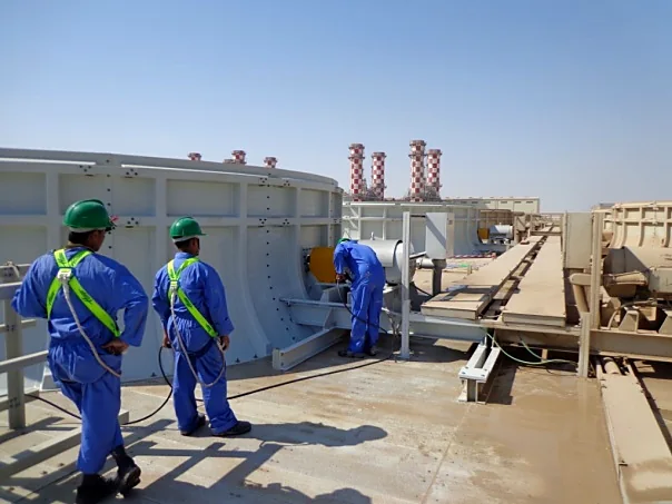 Al Kanar team carrying out maintenance on a cooling tower deck